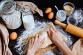 Female hands preparing dough in the kitchen. Baking ingredients on the wooden table Royalty Free Stock Photo