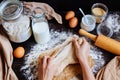 Female hands preparing dough in the kitchen. Baking ingredients on the wooden table Royalty Free Stock Photo