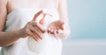 Female hands pumping out cream, lotion, liquid soap from a white bottle, selective focus. Skin body care concept Royalty Free Stock Photo