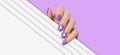 Female hands with purple manicure nails, hearts design