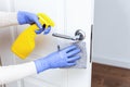 Hands in gloves disinfecting door handle with rag and spray detergent Royalty Free Stock Photo