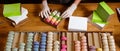 Female hands puts colorful macaroons in a paper box