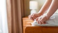 Female Hands puts on new mattress pad on mattress corner. Bed linen at home or hotel. Sheet is worn on soft clean Royalty Free Stock Photo