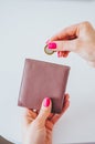 Young woman putting coin in purse. Leather purse for coins.Wallet in hand Royalty Free Stock Photo