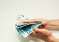 female hands recount Euro banknotes of different denominations