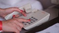 Female hands with red manicure dialing phone number closeup Royalty Free Stock Photo