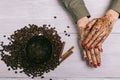 Female hands with red nail polish and applied coffee scrub on th