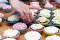 Female hands removing from baking tin home baked cupcakes