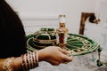 Female hands with round golden emerald green velvet indian tray