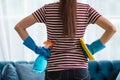 Female hands in rubber gloves cleaning glass with microfiber cloth and spray disinfectant, doing cleaning at home