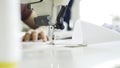 Female hands on white sewing machine, close up shot