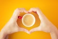 Female hands in the shape of heart holding a cup of coffee Royalty Free Stock Photo