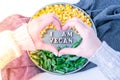 Female hands in shape of heart love I AM VEGAN text in plate. Veganism, vegetarian healthy lifestyle. Healthy eating