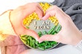 Female hands in shape of heart love I AM VEGAN text in plate. Veganism, vegetarian healthy lifestyle. Healthy eating vegan, green Royalty Free Stock Photo