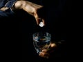 Female hands showing effervescent tablet and glass of water