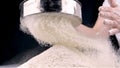 Female hands sifting flour