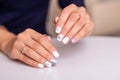 Female hands with silver colored manicure nails