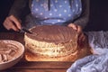 Female hands smeared chocolate cream with a knife.