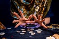 The female hands of the soothsayer read the runes. The zodiac circle glows above the runes. Close up. The concept of divination, Royalty Free Stock Photo