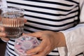 Female hands sorting pills Organizer weekly shots Glass of water Closeup of medical pill box with doses of tablets for Royalty Free Stock Photo