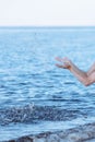 Female hands with splashes of clear blue fresh water in sea. Air bubbles, water drops, sea wave on blue background with Royalty Free Stock Photo