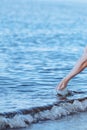 Female hands with splashes of clear blue fresh water in sea. Air bubbles, water drops, sea wave on blue background with Royalty Free Stock Photo