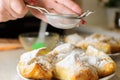 Female Hands Sprinkle Powdered Sugar On Apple Puffs