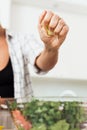 Female hands squeezing and adding lemon juice to vegetarian salad