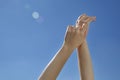 Female hands stretching after waking up to the blue sky Royalty Free Stock Photo