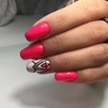 Female hands with stylish red manicure on grey background