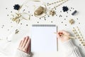 Female hands in sweater and writing. New year resolution, wish list concept. Blank paper letter mockup. Golden party Royalty Free Stock Photo