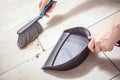 Female Hands Sweeping Dust With A Broom On A Dustpan, Housekeeping Concept