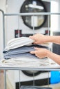 Female hands take a clean towel from the shelf