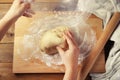 Female Hands taking of Dough for baking pie, or pizza from bowl Homemade Preparing Food. Top view. Rustic background.