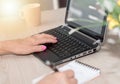 Female hands taking notes and working on laptop, light effect Royalty Free Stock Photo