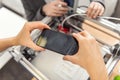 Female hands taking photo of 3D printer creating model