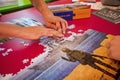 female hands of a teenager put together a puzzle in support of ukraine.