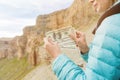 Female hands of a tourist with a fan of dollar bills against the backdrop of the rocks on the journey. The concept of Royalty Free Stock Photo