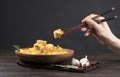 The female hands Traditional Delicious Asian pilaf in a wooden plate