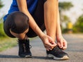 Female hands tying shoelace on running shoes before practice. Ru Royalty Free Stock Photo