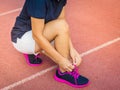 Female hands tying shoelace on running shoes before practice. Ru Royalty Free Stock Photo