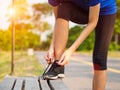 Female hands tying shoelace on running shoes before practice. Ru Royalty Free Stock Photo