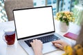 Female hands typing on laptop computer keyboard with isolated screen