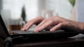 Female hands typing on laptop keyboard, interrupted right hand raises mug with tea lowers mug, work resumes. Social