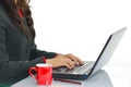 Female hands typing on laptop keyboard at office desk isolated on white background Royalty Free Stock Photo