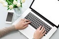 Female hands typing laptop keyboard with screen on tabl Royalty Free Stock Photo