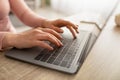 Female hands typing on laptop keyboard, surfing internet or working from home during covid-19 pandemic. Royalty Free Stock Photo