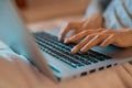 Female hands typing text on laptop computer, searching information in social networks, female keyboarding text. Royalty Free Stock Photo