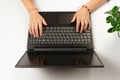 Female hands are typing text on laptop keyboard on white table background Royalty Free Stock Photo