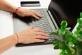 Female hands are typing text on laptop keyboard on white table background Royalty Free Stock Photo